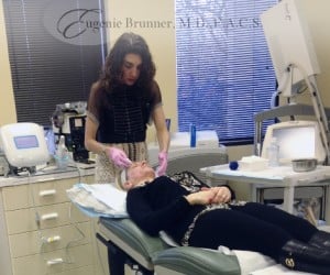 Dr. Brunner performing a cosmetic treatment on a patient at her medical spa in Princeton