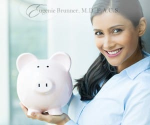 stock image of a woman holding a piggy bank for blog about how much a rhinoplasty costs in Princeton, NJ