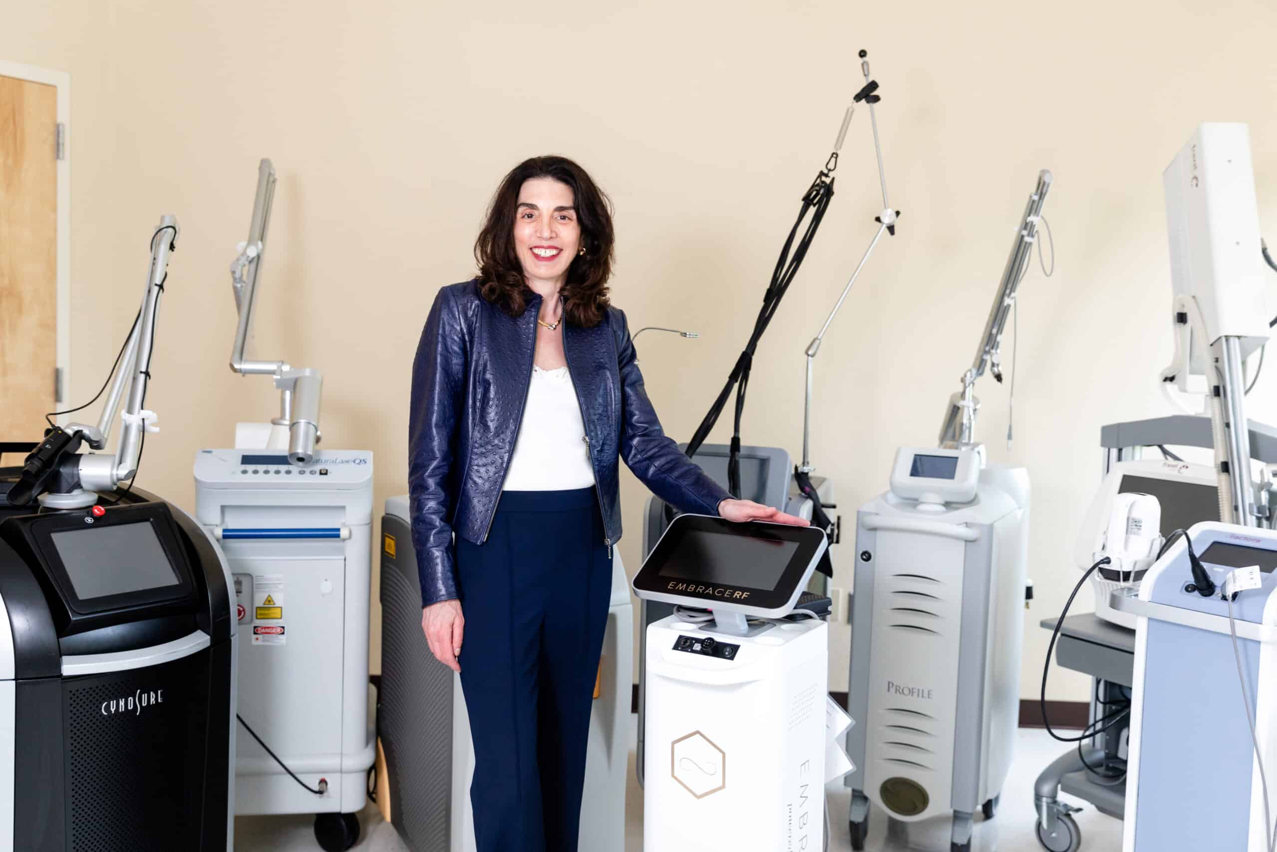 Dr. Brunner next to a laser in her Princeton office