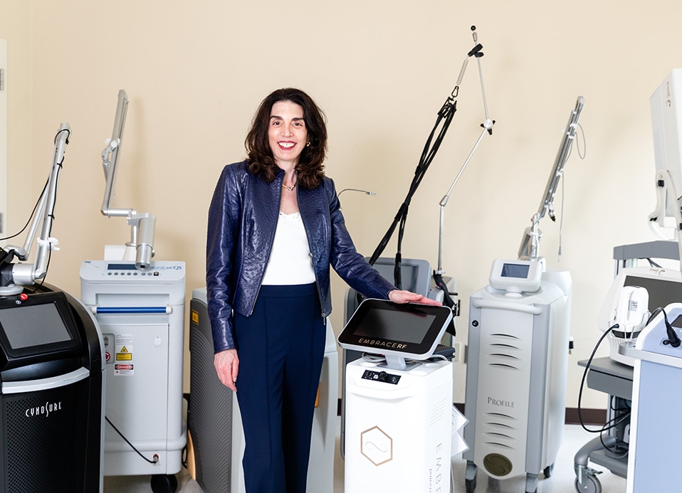 Dr. Brunner next to a laser in her Princeton office