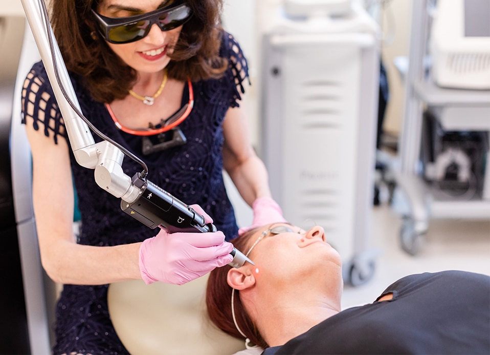 Dr. Brunner performing a non-surgical skin tightening treatment on a patient in Princeton