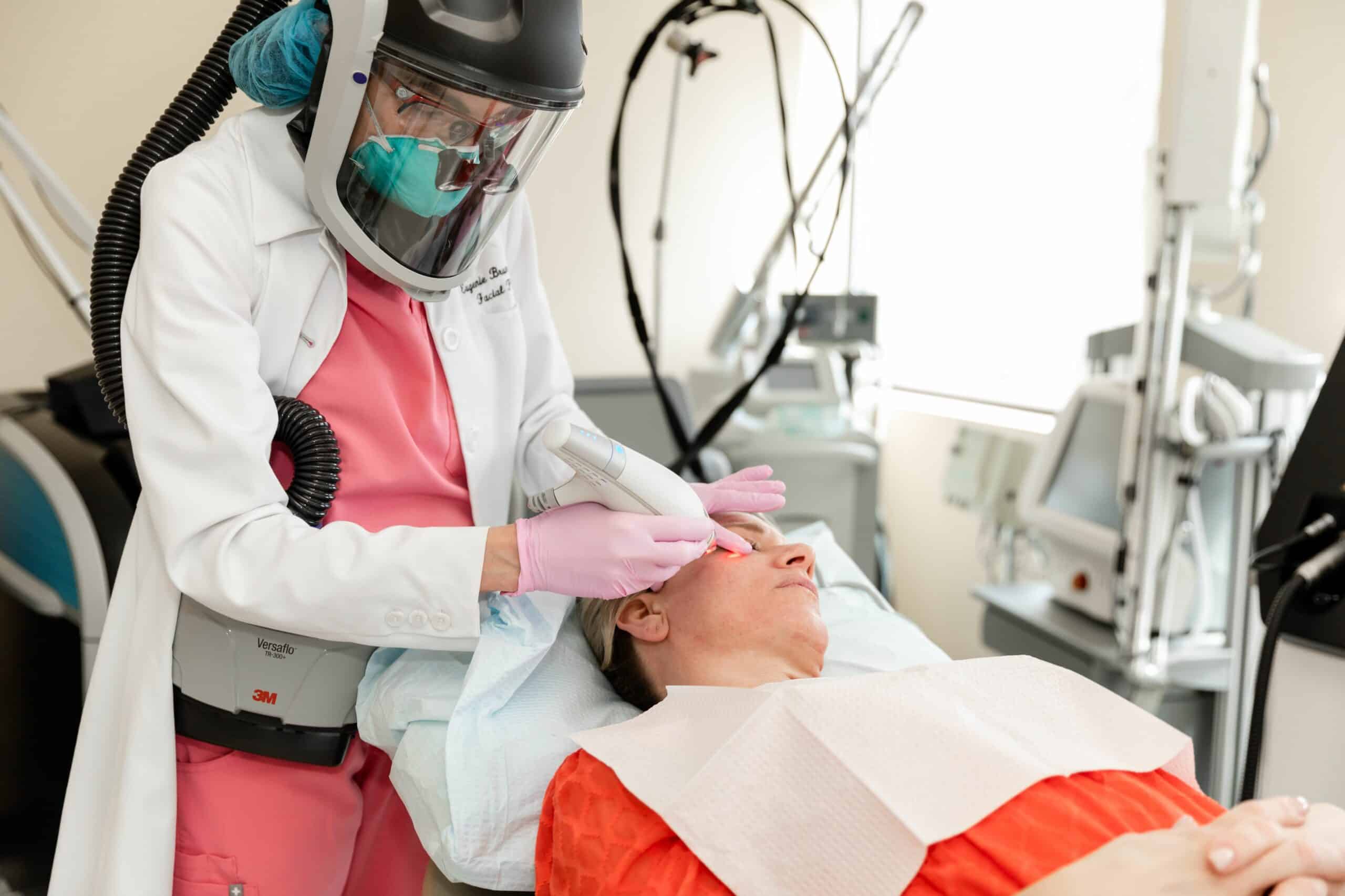 Dr. Brunner performing a jawline contouring treatment at her Princeton medical spa